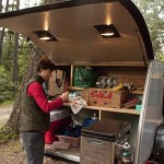 Cooking in the back of a DIY Teardrop Camper Trailer with a double stove slideout.