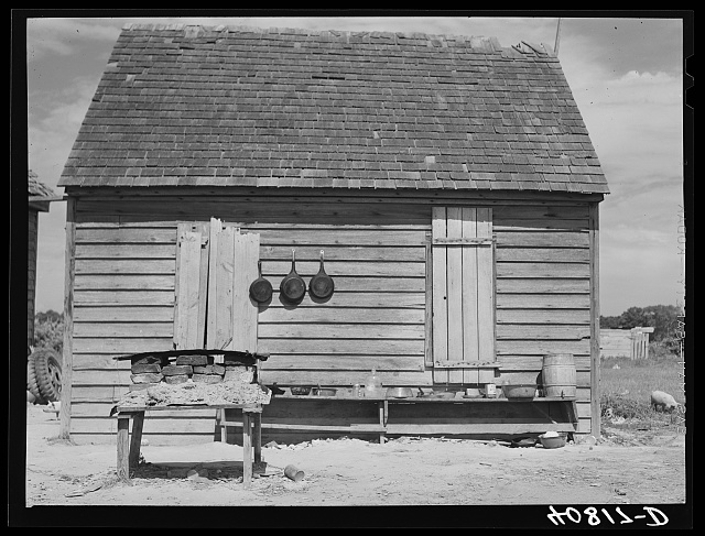 Outdoor Kitchen. Stove in foreground and cooking utensils. Near Old Trap, North Carolina. July 1940