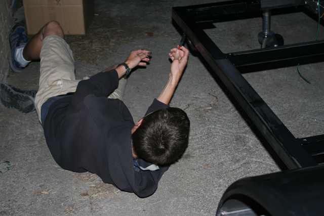 Slaves work on the underside of the trailer